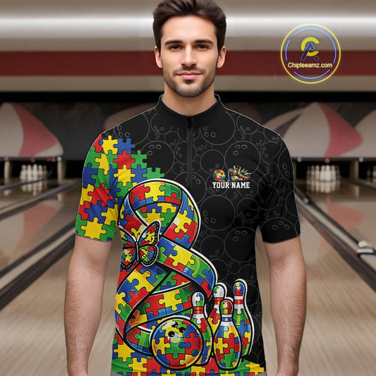 Male Model At Bowling Lane, Front View, Wearing Black Quarter-Zip Shirt With Autism Awareness Ribbon Puzzle Motif, Butterfly Accent And Bowling Strike Scene