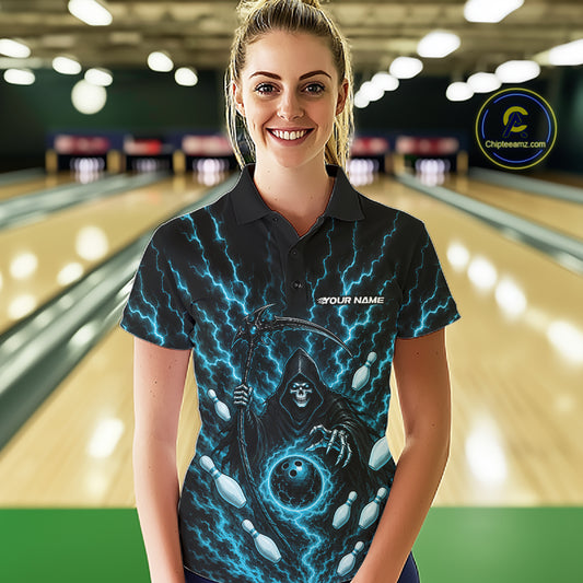 A woman wearing a black short-sleeve polo shirt with a blue lightning design and a grim reaper graphic, standing in front of a blurred bowling alley background. The shirt has 'YOUR NAME' printed on the chest
