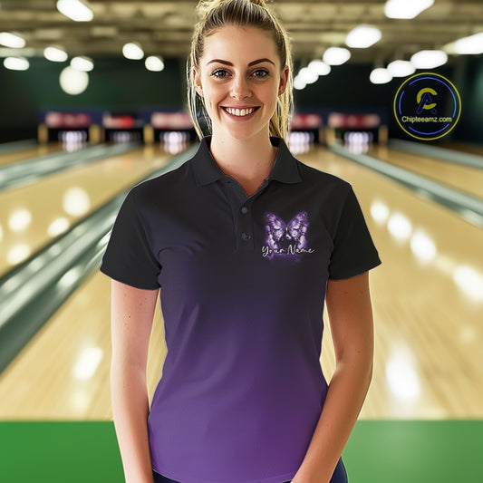 Female model wearing a purple bowling polo shirt at a bowling lane with glowing butterfly artwork, a bowling ball, and cosmic accents.