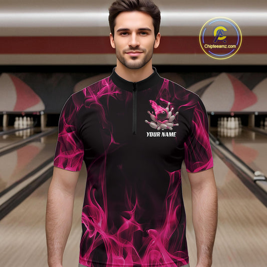 Male model wearing a black and pink bowling quarter-zip shirt at a bowling lane with bowling action artwork and fiery background details.
