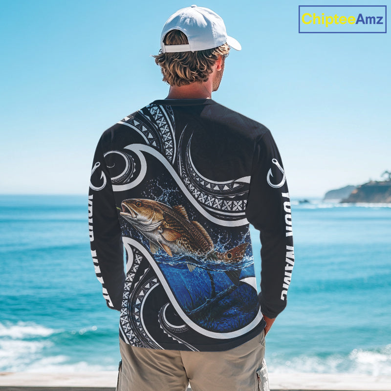 Angler wearing blue tribal pattern custom redfish long sleeve fishing shirt on the water