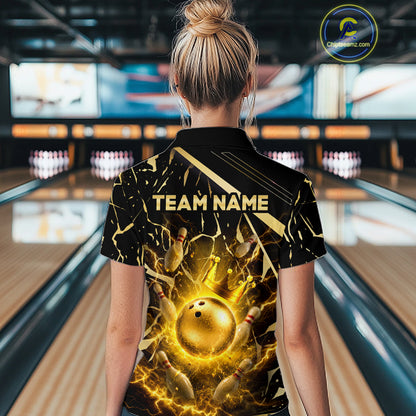 Female model wearing a custom black gold bowling quarter-zip shirt back view displaying the personalized team name above a glowing bowling ball with lightning energy artwork at the bowling alley