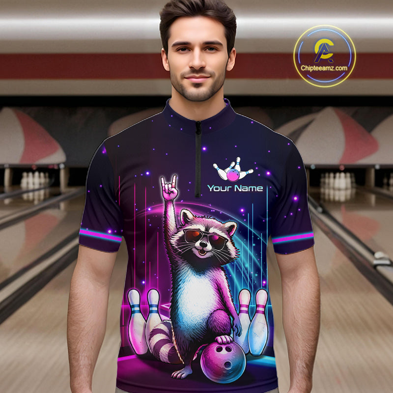 A man wearing a short-sleeve cycling jersey with a colorful graphic of a raccoon bowling, set against a blurred bowling alley background. The jersey features a dark purple base with neon pink, blue, and purple accents, and includes placeholder text 'Your Name' and a bowling pin logo.