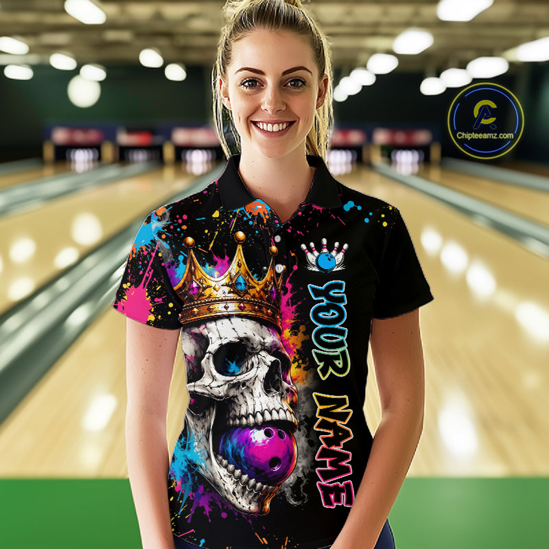 Woman wearing a colorful bowling shirt with a skull design in a bowling alley.