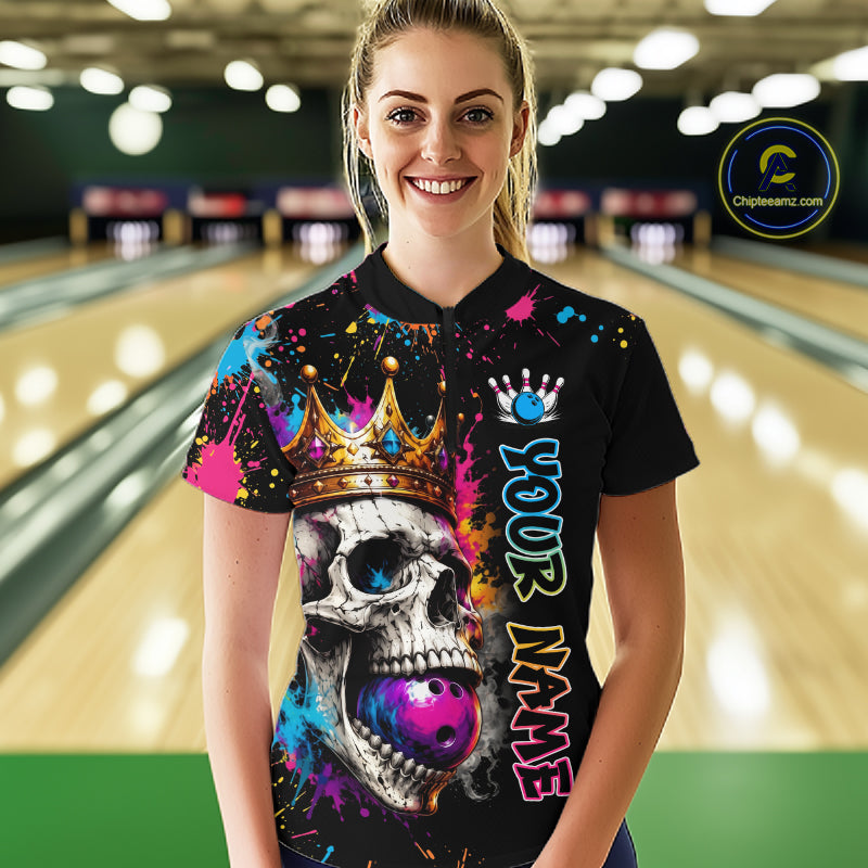 Person wearing a black shirt with colorful skull design and 'Your Name' text in a bowling alley.