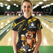 Load image into Gallery viewer, A woman wearing custom black yellow bulldog bowling polo shirt front view featuring a bowling ball, beer mug and yellow paint splash pattern, displaying Team Name, at the bowling alley