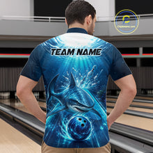 Load image into Gallery viewer, Man wearing a blue bowling shirt with shark design and 'TEAM NAME' text on the back, in a bowling alley.