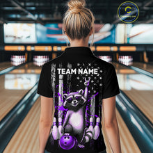 Load image into Gallery viewer, Person wearing a black shirt with a raccoon graphic and 'TEAM NAME' text in a bowling alley.