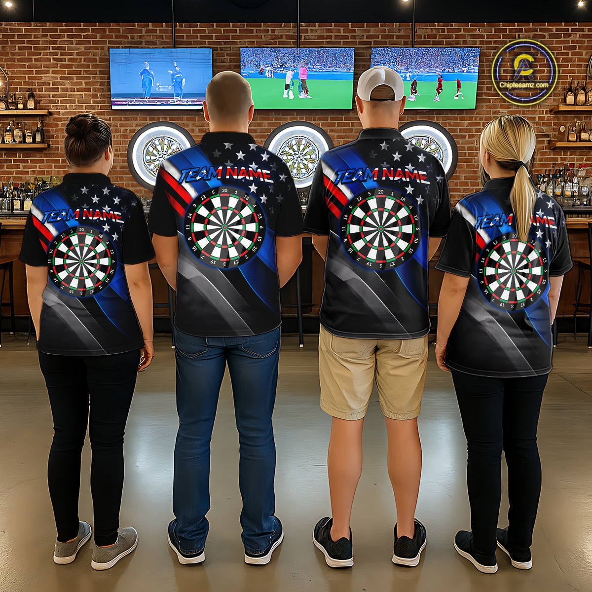 Back view of four people wearing matching custom dart polo shirts with personalized team names and patriotic dartboard graphics with red, blue, and silver diagonal stripes in a professional dart room.