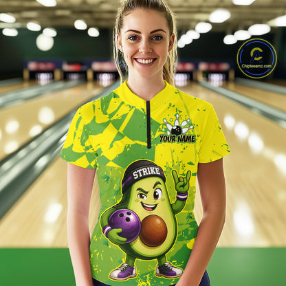 Person wearing a colorful bowling jersey with an avocado character design in a bowling alley.