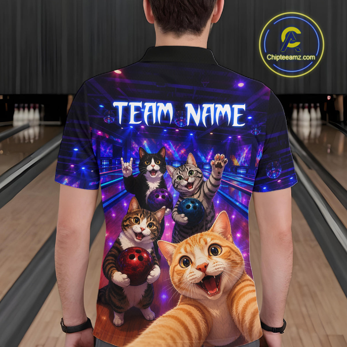 Person wearing a colorful bowling shirt with cartoon cats and 'Team Name' text in a bowling alley.