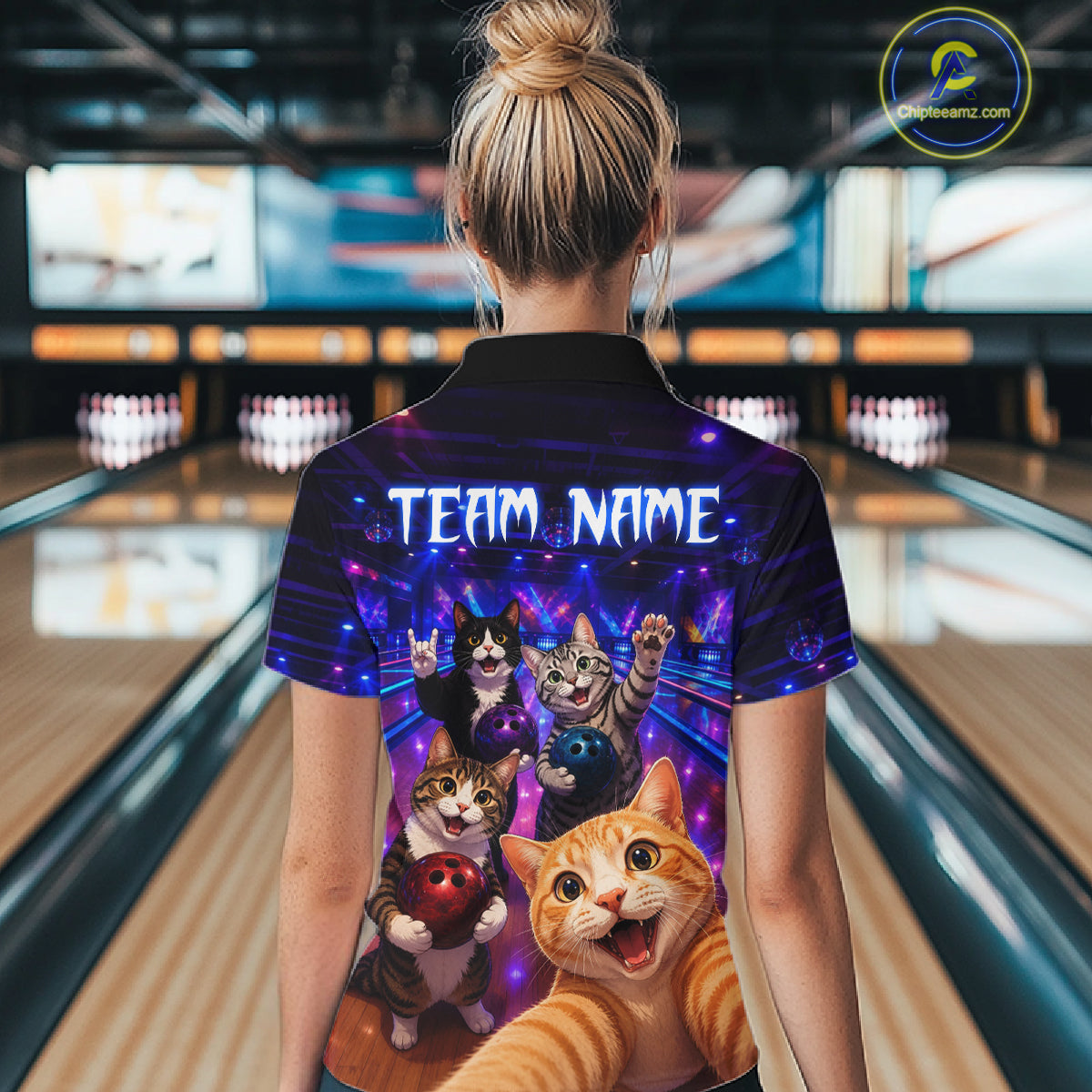 Person wearing a colorful shirt with cartoon cats in a bowling alley