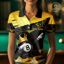 Load image into Gallery viewer, Woman wearing custom black and gold geometric crown 8 ball billiard polo shirt standing at a pool table in a billiard room