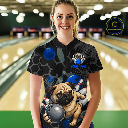 Person wearing a bowling shirt with a pug design in a bowling alley.