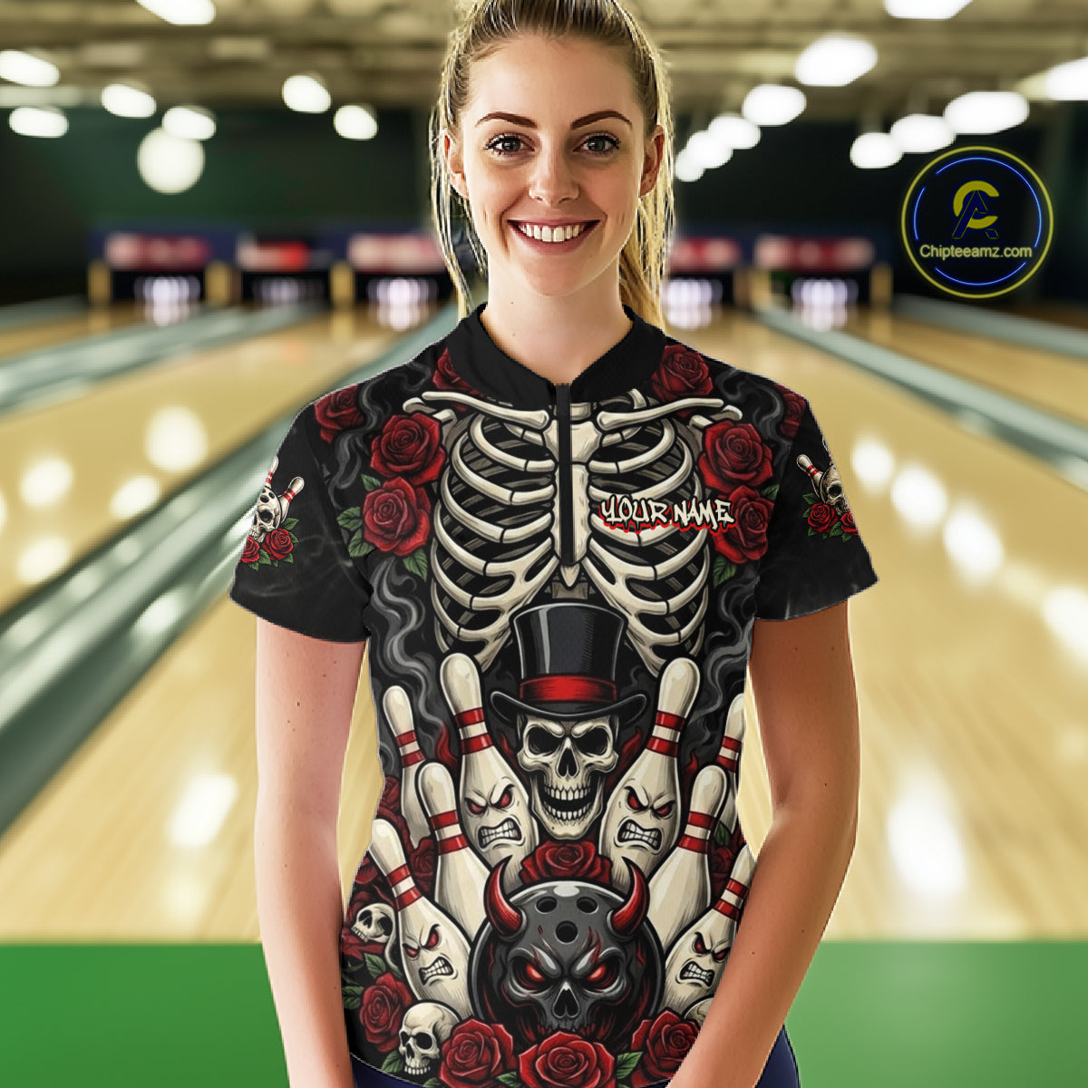 A woman standing in a bowling alley wearing a black short-sleeve bowling shirt with a detailed skeleton and skull graphic featuring red roses and bowling pins. The shirt has 'YOUR NAME' printed on the chest.