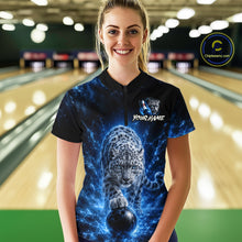 Load image into Gallery viewer, Woman wearing a black shirt with a blue and white design of a leopard and text in a bowling alley.