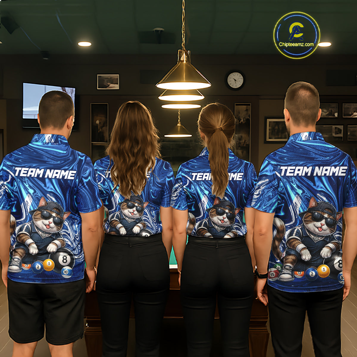 Four people wearing matching blue team jerseys with a cat and billiard ball design in a room.
