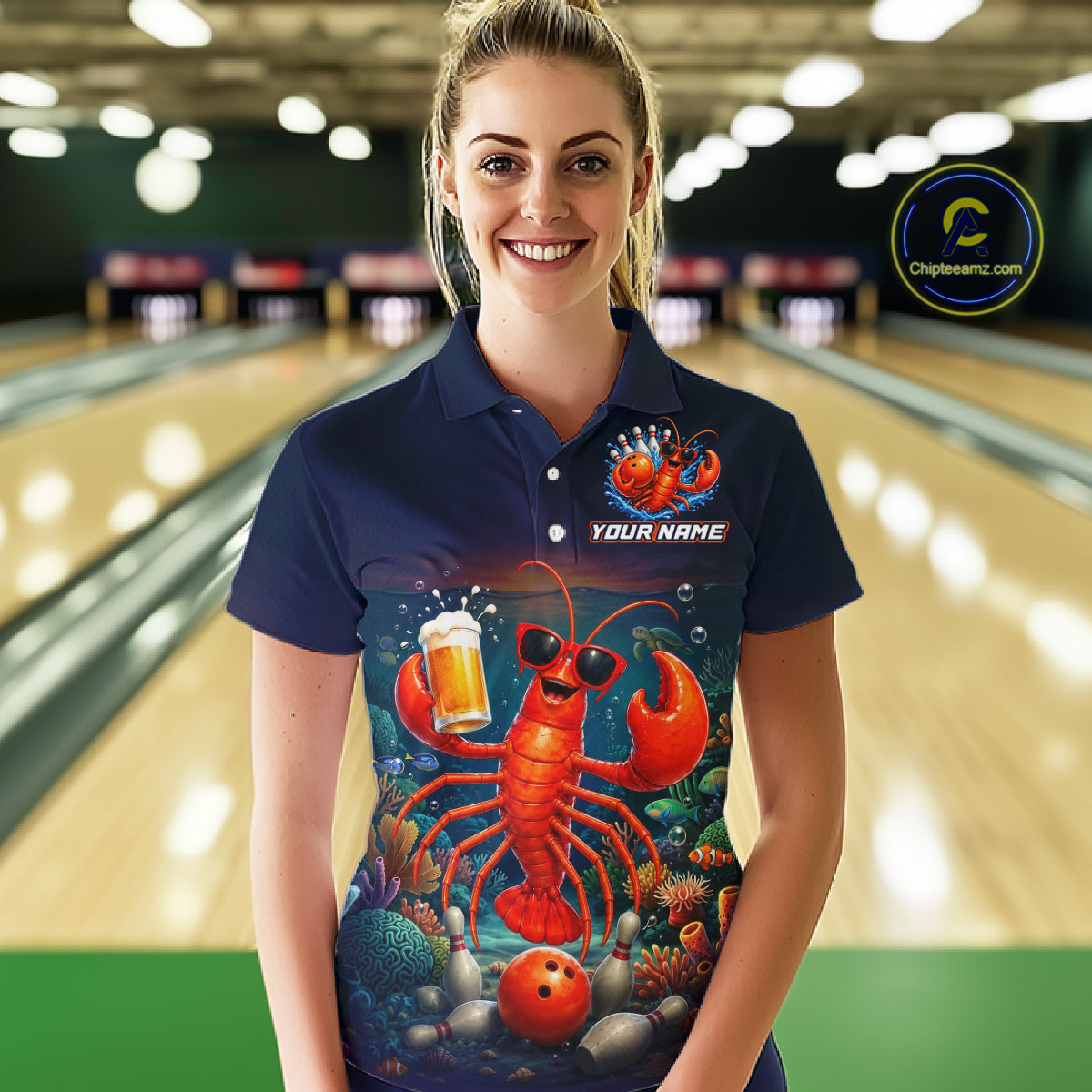 Person wearing a navy blue polo shirt with a colorful lobster design in a bowling alley.