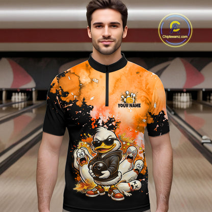 A man wearing a short-sleeve bowling jersey with a black collar and a colorful graphic print featuring cartoon ducks and bowling pins, set against a blurred bowling alley background. 