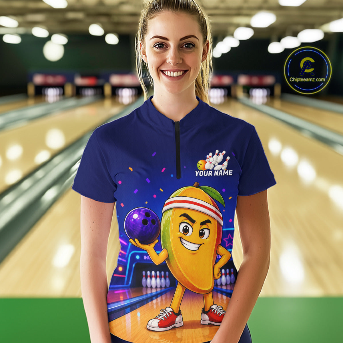 Person wearing a blue bowling shirt with a colorful design in a bowling alley.