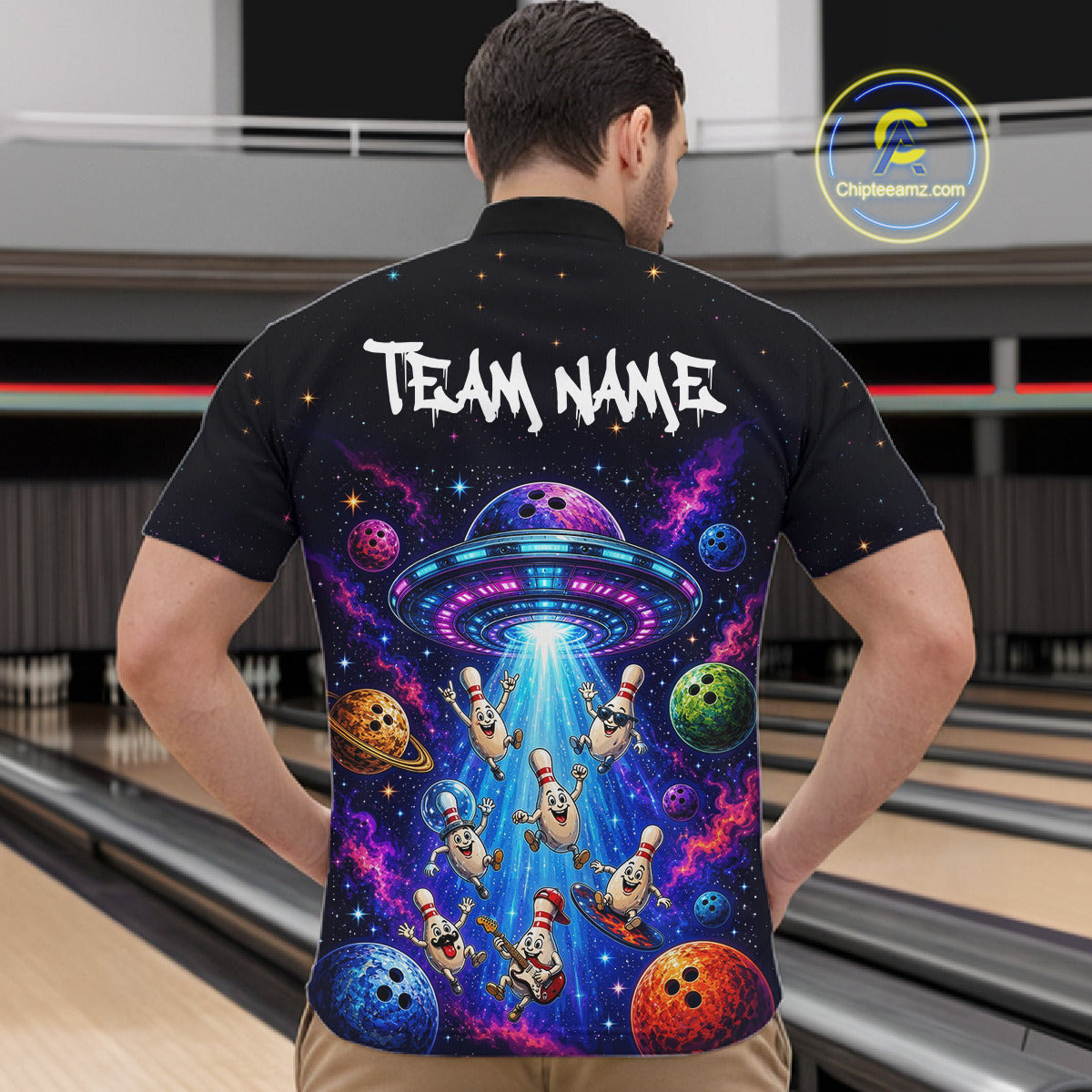 Person wearing a black shirt with a colorful alien abduction design and 'Team Name' text.