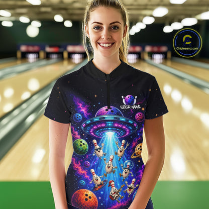 Person wearing a colorful bowling shirt with alien design in a bowling alley.