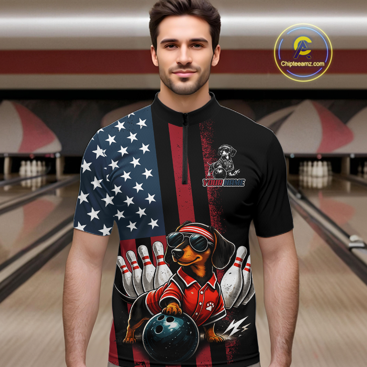 Man wearing a black polo shirt with a dachshund graphic and American flag design in a bowling alley.