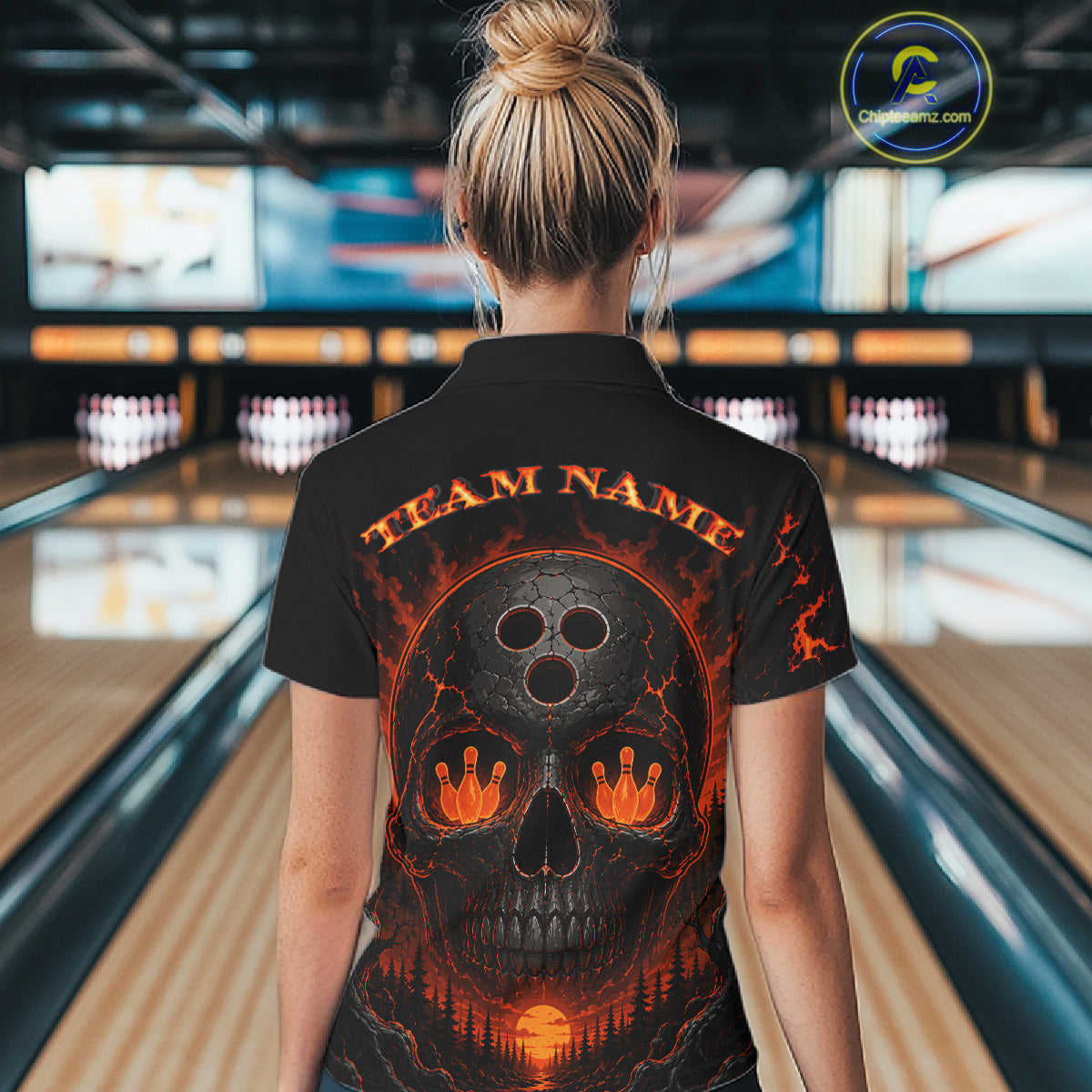 Person wearing a black bowling shirt with a skull design and 'Team Name' text in a bowling alley.
