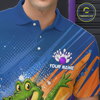 A close-up of a blue short-sleeve polo shirt with bowling-themed graphics, including a green alligator, orange diagonal stripes, a bowling pin and ball motif, and the text 'YOUR NAME'.