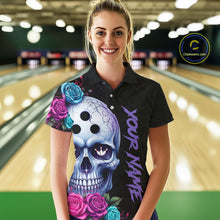 Load image into Gallery viewer, Woman wearing a black bowling shirt with a colorful skull design in a bowling alley.