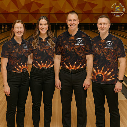 Four people standing in a bowling alley wearing matching black short-sleeve bowling shirts with a fiery orange and yellow flame-and-ball graphic, paired with black pants. A bowling pin lane and wooden lanes are visible in the background