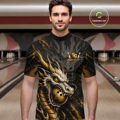 A man wearing a short-sleeve bowling shirt with a large gold and black dragon graphic, standing in a bowling alley. The shirt features a mock neck, a short zipper, and a customizable chest graphic with a skull and crossed bowling pins.