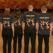 Load image into Gallery viewer, Group of four wearing custom black gold bowling shirts back view featuring a fiery bowling ball and flame burst effect, displaying Team Name, at the bowling alley