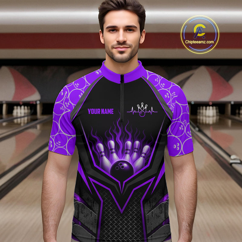 Man wearing a black and purple bowling shirt with a design on a bowling alley background