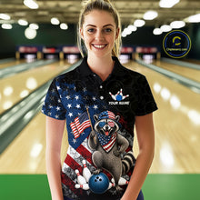 Load image into Gallery viewer, Women’s us flag raccoon bowling polo shirt, front view on female model in bowling lane 