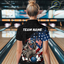 Load image into Gallery viewer, Women’s us flag raccoon bowling polo shirt, back view on female model in bowling lane 