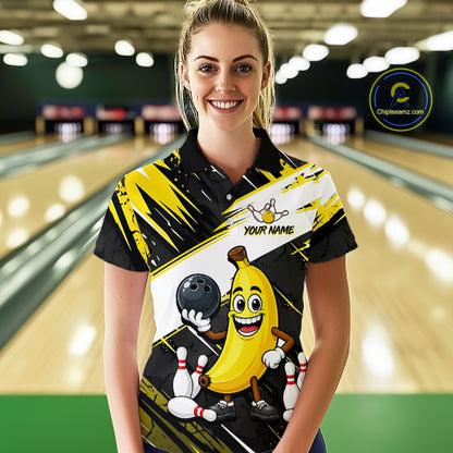Women wearing a bowling-themed shirt with a cartoon banana character in a bowling alley.