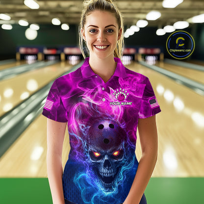 A woman standing in a bowling alley wearing a short-sleeve collared shirt with a vivid purple, pink, and blue skull graphic on the front. The shirt has a mock neck, short sleeves, and a small chest graphic that reads 'YOUR NAME'.