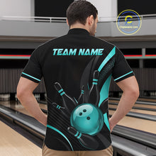 Load image into Gallery viewer, Person wearing a black bowling shirt with a blue design and 'TEAM NAME' text at a bowling alley.