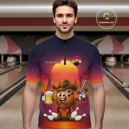 A man wearing a short-sleeve quarter-zip cycling jersey with a colorful cartoon graphic of a cookie character in a cowboy hat, set against a bowling alley background. The jersey features a dark navy-to-orange gradient with a sunset design and the text 'YOUR NAME'.