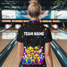 Load image into Gallery viewer, Women wearing personalized bowling quarter zip shirt with cartoon chicks holding bowling balls, framed by pins and colorful paint patterns on a black layout.