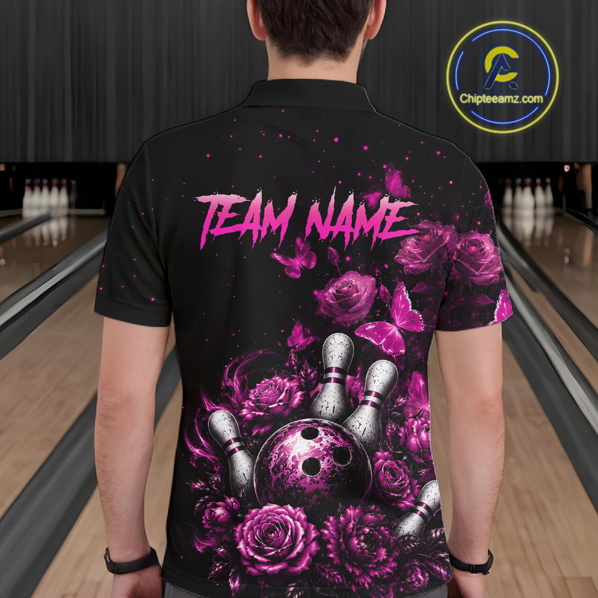 Men’s pink rose butterfly bowling polo shirt, back view on male model in bowling lane 