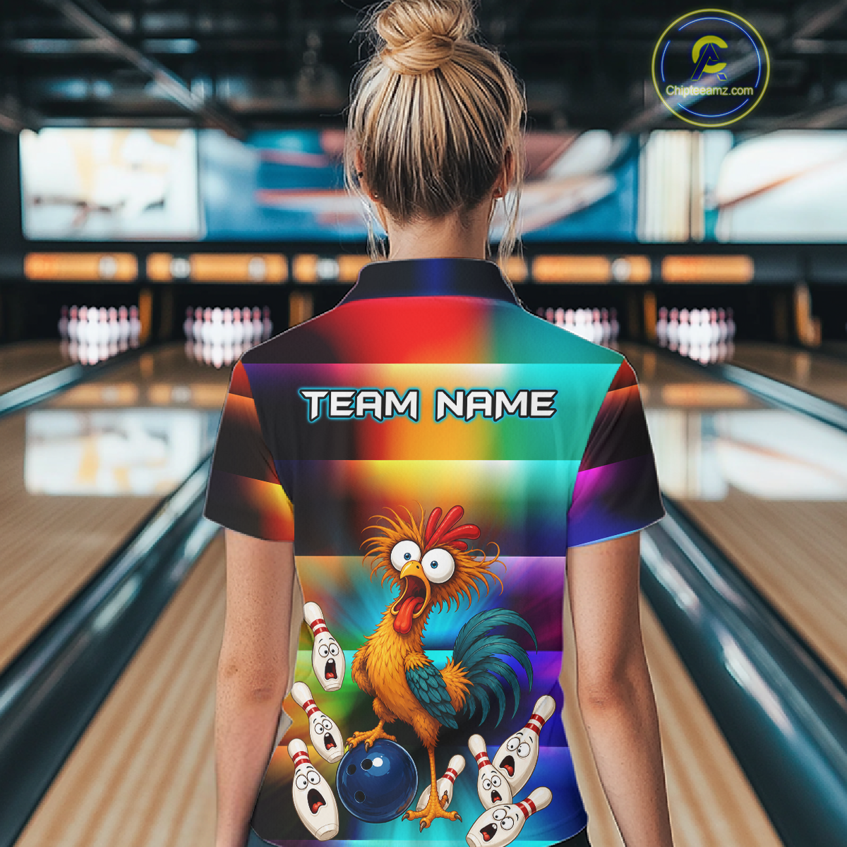 Woman wearing a colorful bowling quarter zip featuring a shocked rooster chicken, blue bowling ball, surprised pins, and custom team name text.