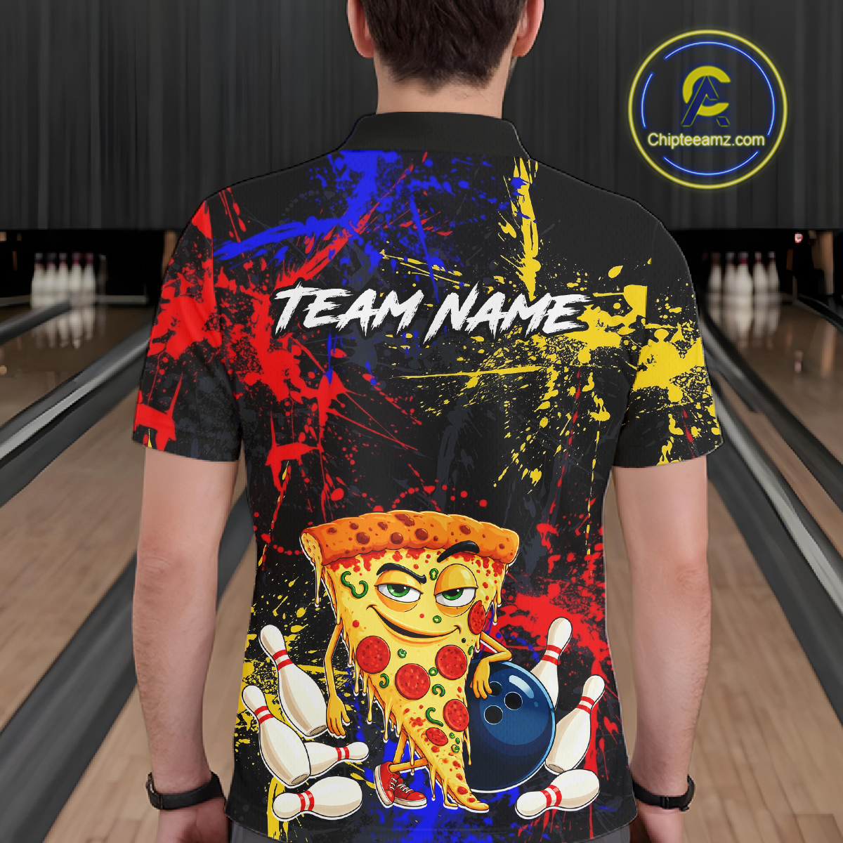 Man wearing a black bowling polo featuring colorful red, yellow, and blue paint splatter graphics, a cartoon pizza slice mascot, bowling pins, and custom team name text.