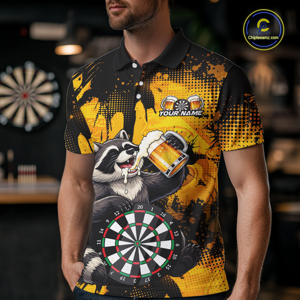 Person wearing a black and yellow darts polo featuring a raccoon drinking beer, dartboard graphics, and custom team and player name text.