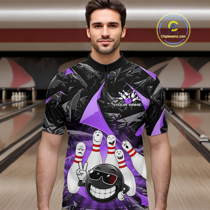 A man wearing a custom bowling-themed short-sleeve t-shirt with a black and purple geometric pattern and cartoon bowling pins and ball graphic. The background shows a blurred bowling alley.