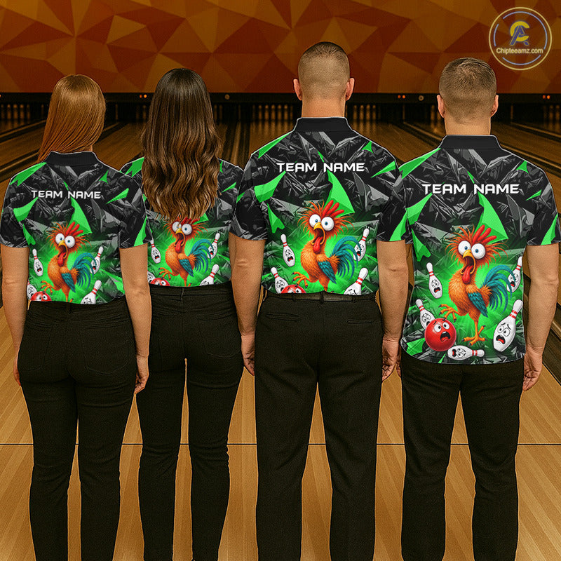 Four people standing side by side from the back in a bowling alley, wearing matching bowling shirts with a colorful cartoon rooster and skull pattern on the back, black collars and black pants. The shirts have 'TEAM NAME' printed on the back.