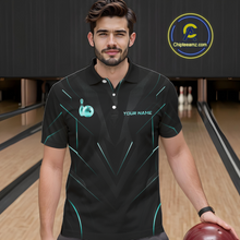 Load image into Gallery viewer, Man wearing a black bowling shirt with teal accents in a bowling alley.