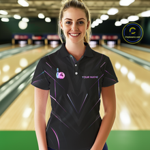 Load image into Gallery viewer, Woman wearing a black bowling shirt with colorful designs in a bowling alley.