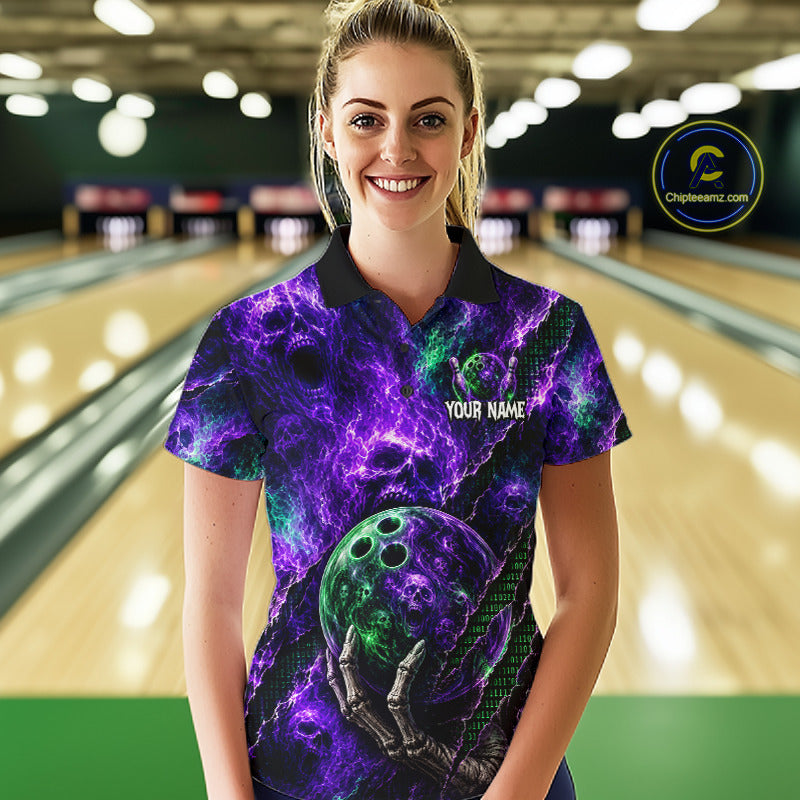 A woman stands in a bowling alley wearing a short-sleeve polo shirt with a purple and black cosmic skull design and a green bowling ball graphic. The shirt has 'YOUR NAME' printed on the chest